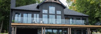 Black home with glass InvisiRail railings.